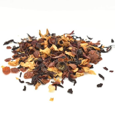 Blood Orange Moon Loose Leaf Tea 🍊🌙 is a caffeine-free herbal blend, scattered in a pile with vibrant red, brown, and yellow chunks—displayed on a white surface.